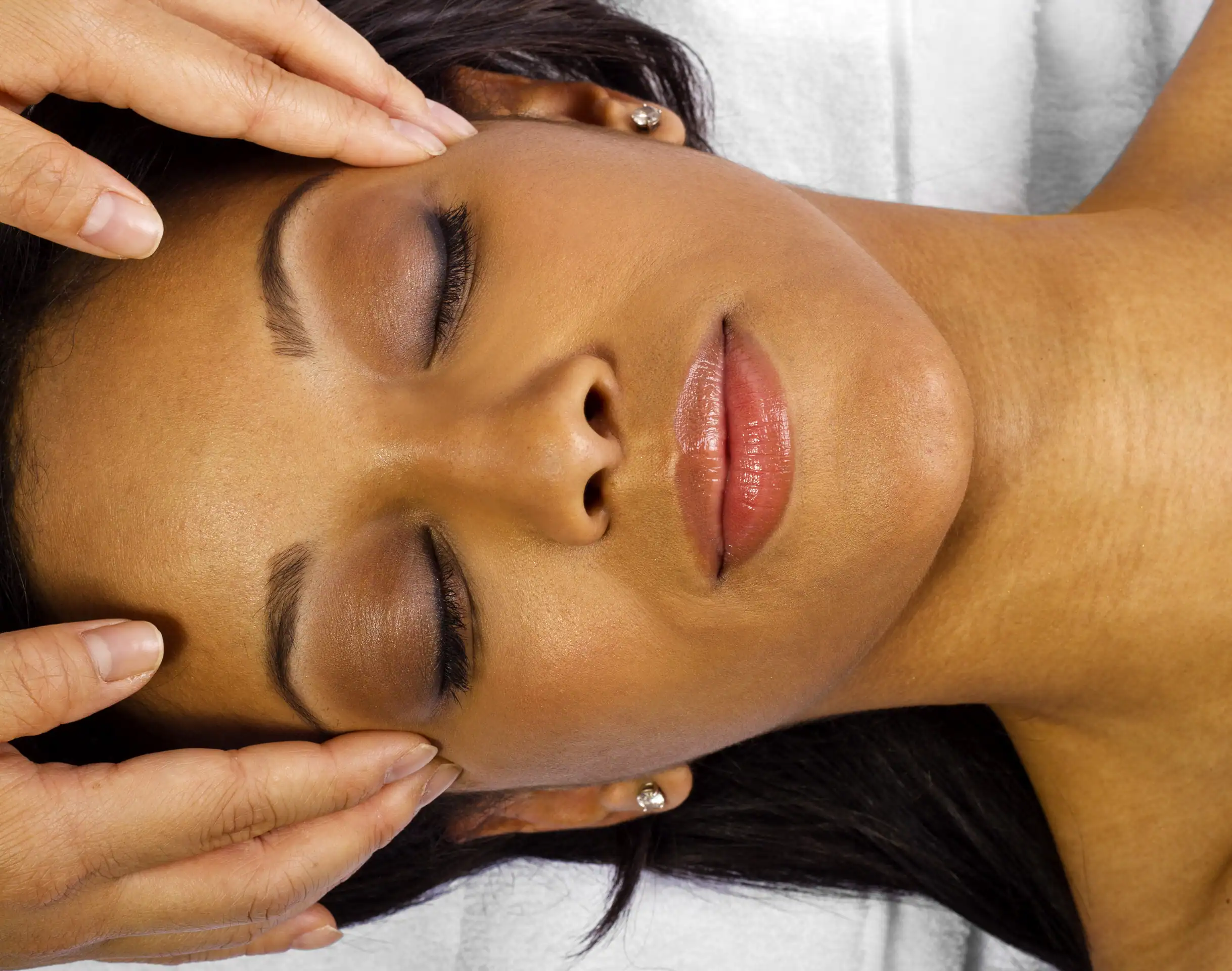 Black woman with perfect skin gets a facial with massage