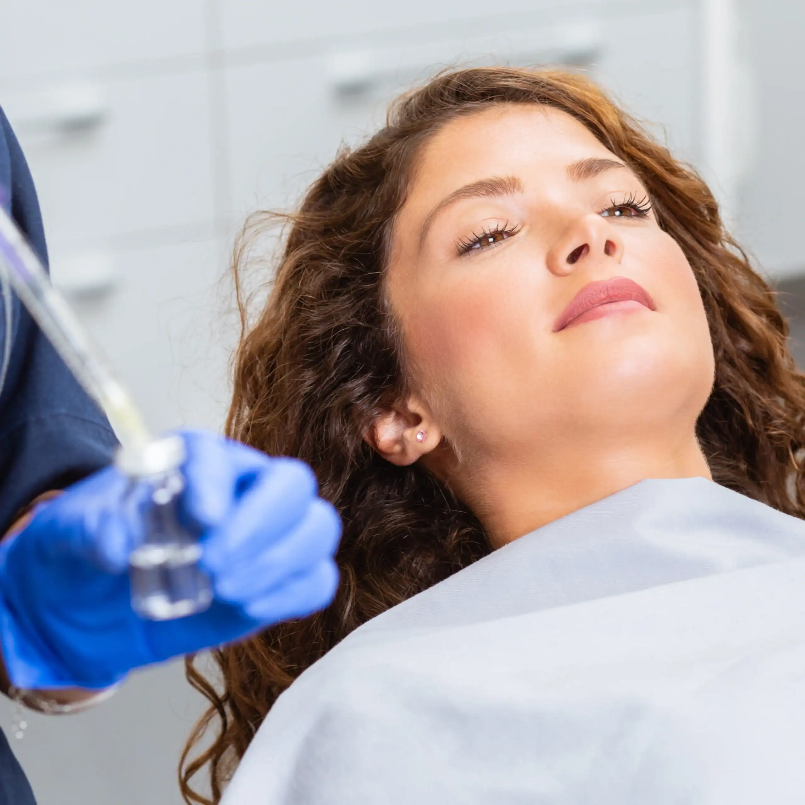 Beautiful woman prepares for a cosmetic injection
